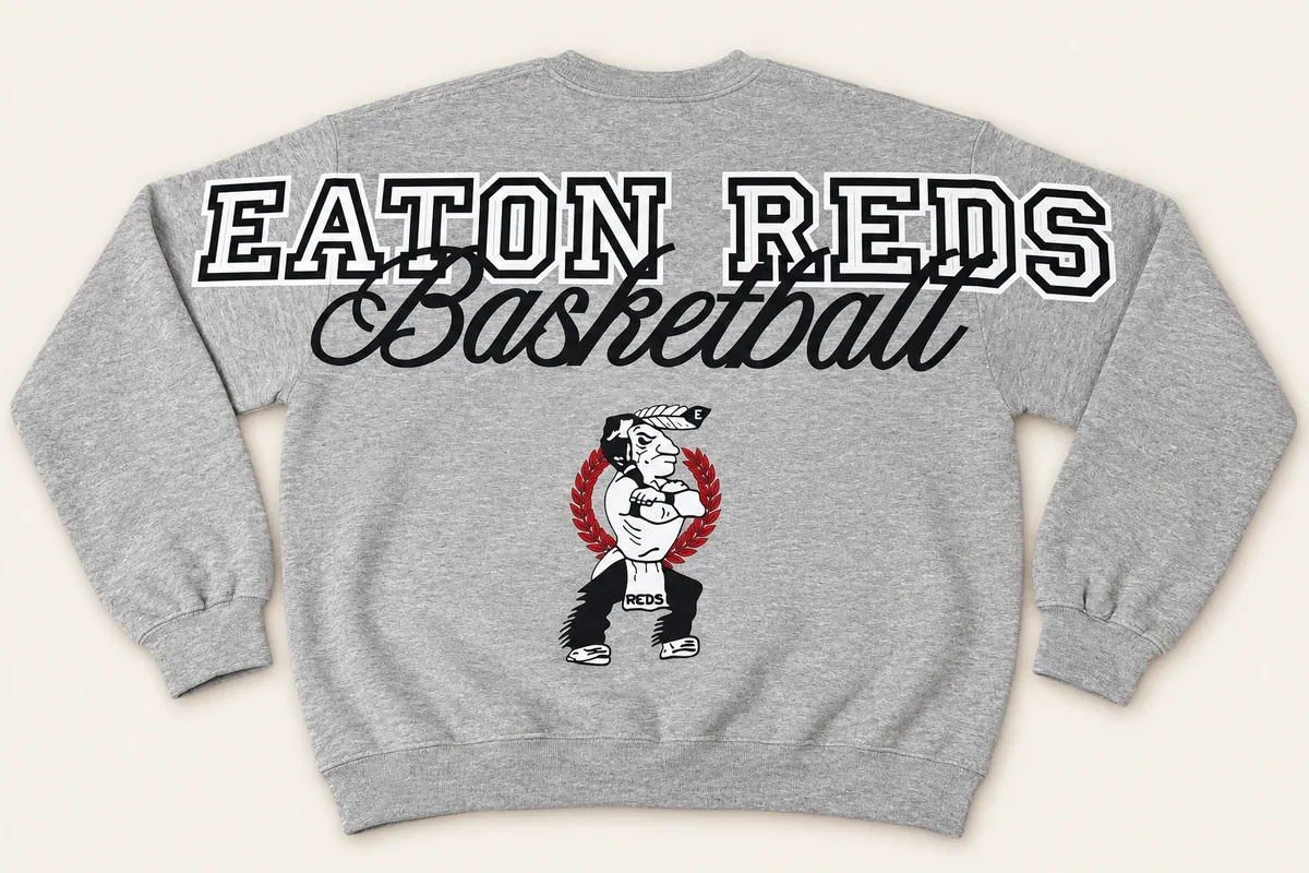 Back of a grey crewneck sweatshirt: EATON REDS across the shoulders and sleeves, Basketball in script, and the team mascot