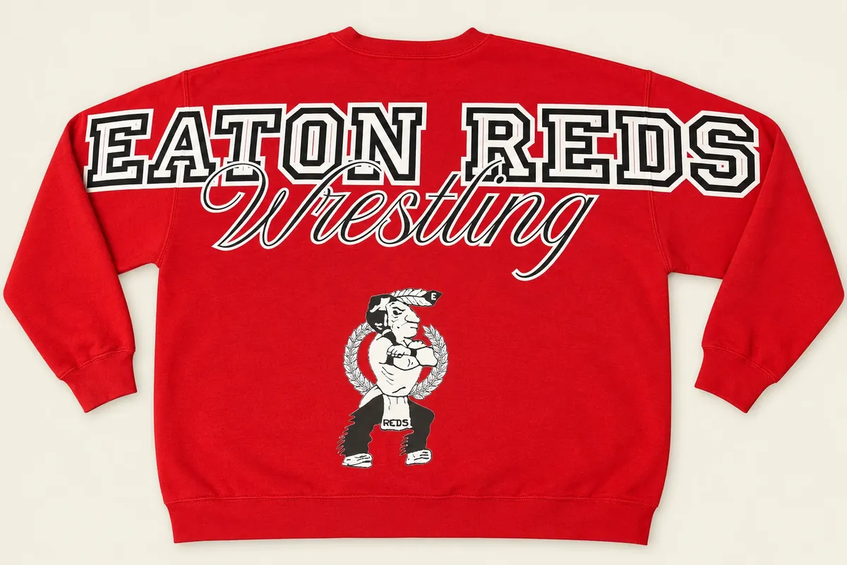 Back of a red crewneck sweatshirt: EATON REDS across the shoulders and sleeves, Wrestling in script, and the team mascot